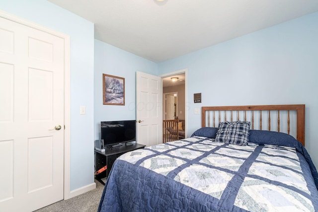 carpeted bedroom featuring baseboards