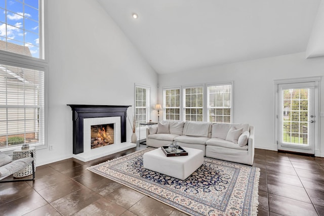 7169 Fernridge Dr, New Albany, OH 43054 - living room with high vaulted ceiling, a lit fireplace, baseboards, and recessed lighting