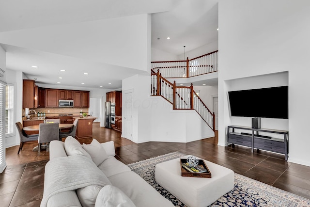 7169 Fernridge Dr, New Albany, OH 43054 - living area with stairs, recessed lighting, dark tile patterned floors, baseboards, and a high ceiling