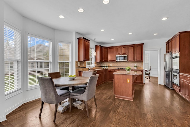 7169 Fernridge Dr, New Albany, OH 43054 - kitchen featuring appliances with stainless steel finishes, a center island, plenty of natural light, recessed lighting, and tasteful backsplash