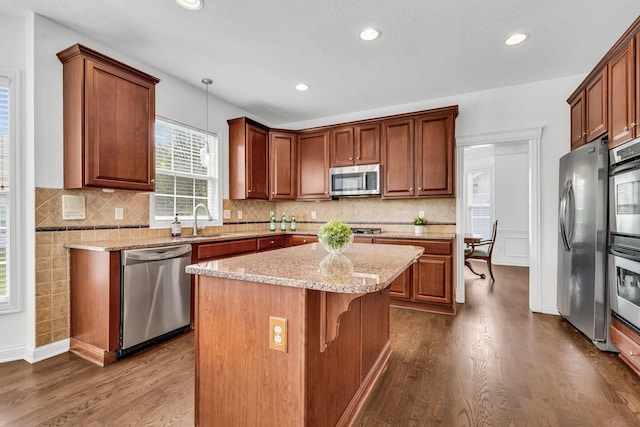 7169 Fernridge Dr, New Albany, OH 43054 - kitchen featuring appliances with stainless steel finishes, dark wood-style floors, a sink, a kitchen island, and recessed lighting