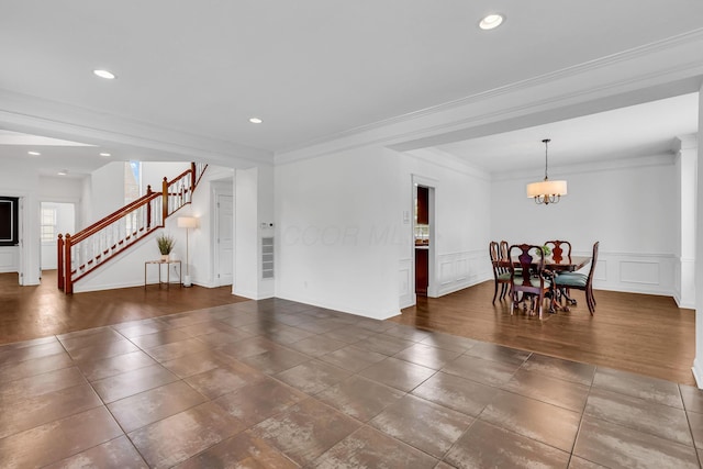 7169 Fernridge Dr, New Albany, OH 43054 - tiled living area with crown molding, stairs, wainscoting, recessed lighting, and a decorative wall