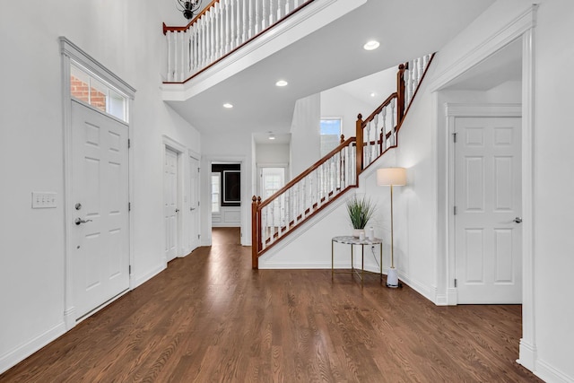7169 Fernridge Dr, New Albany, OH 43054 - entrance foyer with stairway, wood finished floors, baseboards, and a towering ceiling