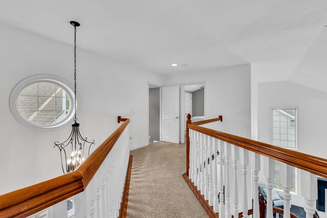 7169 Fernridge Dr, New Albany, OH 43054 - hall with an upstairs landing, light colored carpet, recessed lighting, a chandelier, and baseboards
