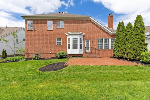7169 Fernridge Dr, New Albany, OH 43054 - rear view of property with brick siding, a patio, a chimney, and a lawn