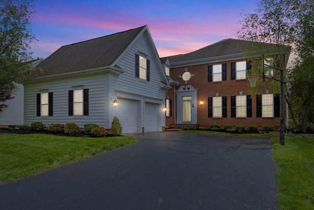 7169 Fernridge Dr, New Albany, OH 43054 - view of front of property with driveway, a garage, a front lawn, and brick siding