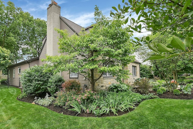 1799 Baldridge Rd, Columbus, OH 43221 - view of side of property with a chimney, a yard, and stone siding