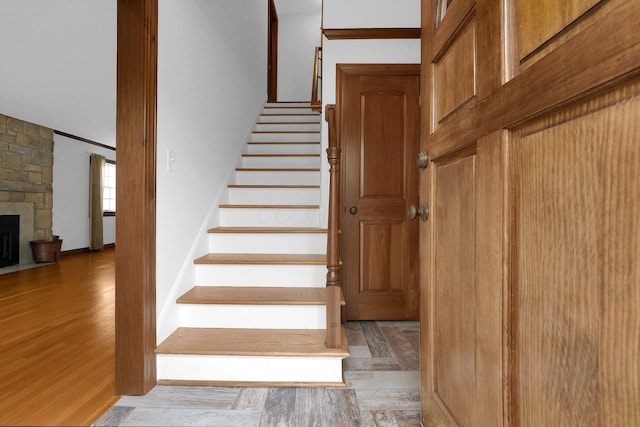 1799 Baldridge Rd, Columbus, OH 43221 - stairway featuring wood finished floors and a stone fireplace