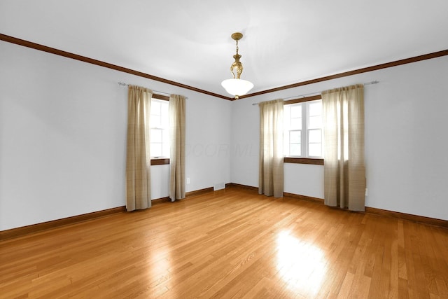 1799 Baldridge Rd, Columbus, OH 43221 - empty room with healthy amount of natural light, ornamental molding, light wood-style flooring, and baseboards