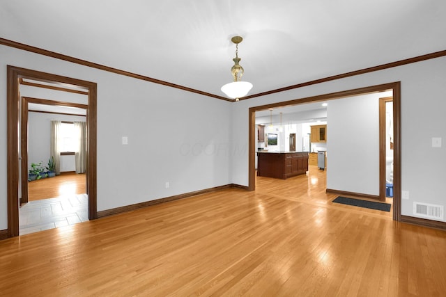 1799 Baldridge Rd, Columbus, OH 43221 - empty room with ornamental molding, baseboards, and light wood-style floors