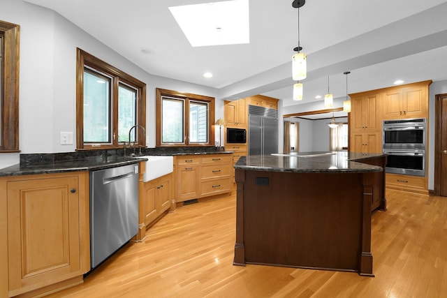 1799 Baldridge Rd, Columbus, OH 43221 - kitchen featuring built in appliances, a sink, light wood finished floors, plenty of natural light, and recessed lighting
