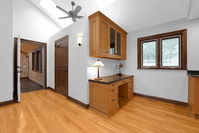 1799 Baldridge Rd, Columbus, OH 43221 - hallway featuring a skylight, light wood-type flooring, baseboards, and vaulted ceiling
