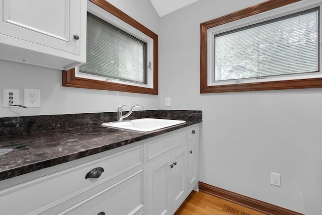 1799 Baldridge Rd, Columbus, OH 43221 - bathroom featuring wood finished floors, vanity, and baseboards