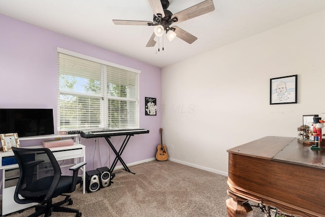 office space with carpet flooring, a ceiling fan, and baseboards