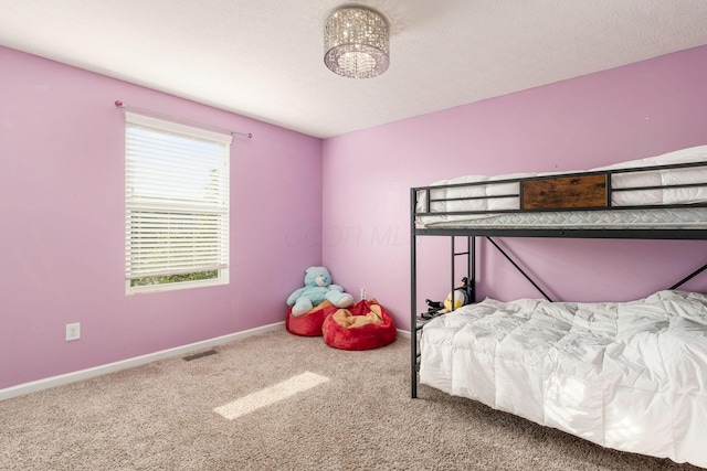 bedroom featuring carpet flooring and baseboards
