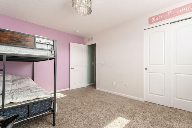bedroom featuring carpet flooring, baseboards, and a closet