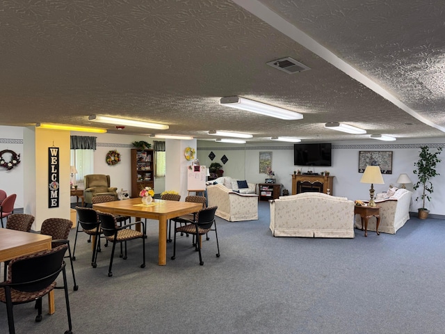 carpeted dining room featuring a fireplace, a textured ceiling, and visible vents