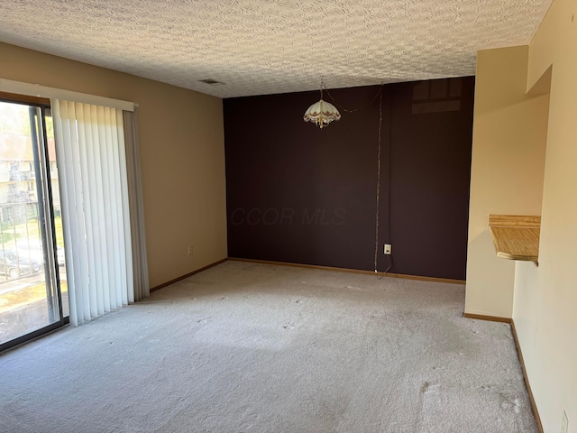 spare room featuring carpet, baseboards, and plenty of natural light