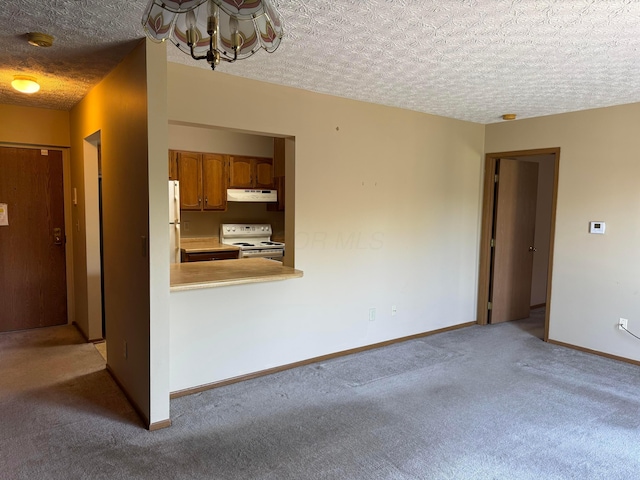 unfurnished living room with light colored carpet, a textured ceiling, a chandelier, and baseboards