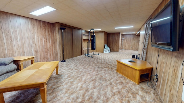 living area featuring carpet floors and wood walls