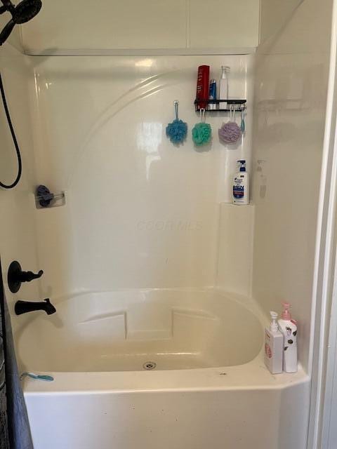 bathroom with walk in shower and a washtub
