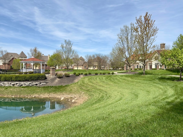 view of community with a lawn, a water view, and a gazebo