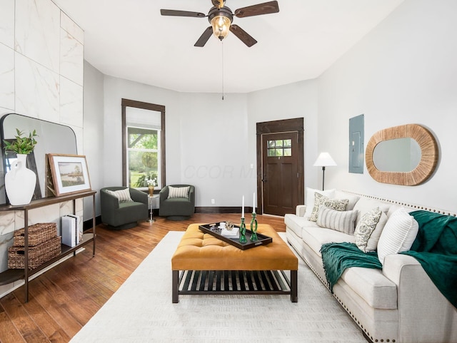 living area featuring ceiling fan, wood finished floors, and electric panel