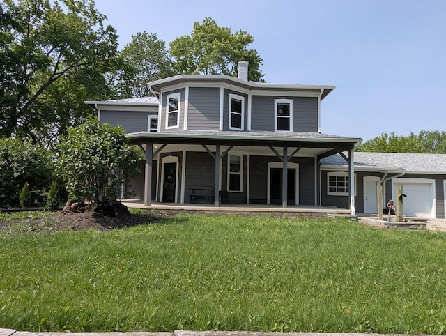 2310 Troy Rd, Delaware, OH 43015 - view of front of home with an attached garage, a chimney, a front lawn, and covered porch