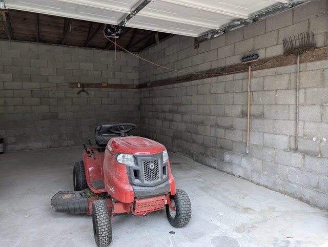 2310 Troy Rd, Delaware, OH 43015 - garage featuring concrete block wall and a garage door opener