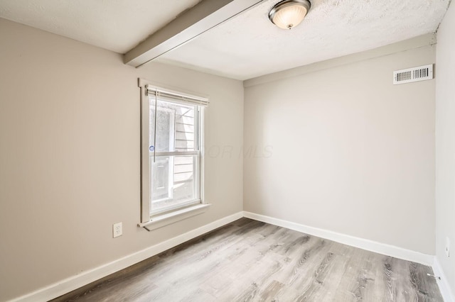 1273 Minnesota Ave, Columbus, OH 43211 - spare room featuring wood finished floors, beam ceiling, and baseboards