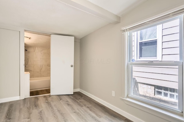 1273 Minnesota Ave, Columbus, OH 43211 - unfurnished bedroom featuring light wood finished floors, baseboards, and ensuite bath