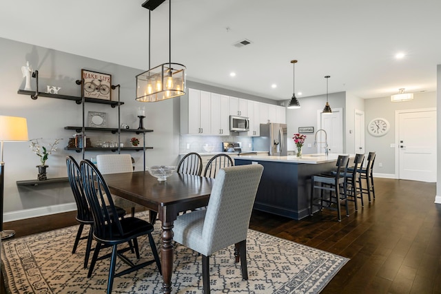 dining room featuring baseboards, recessed lighting, dark wood finished floors, and visible vents