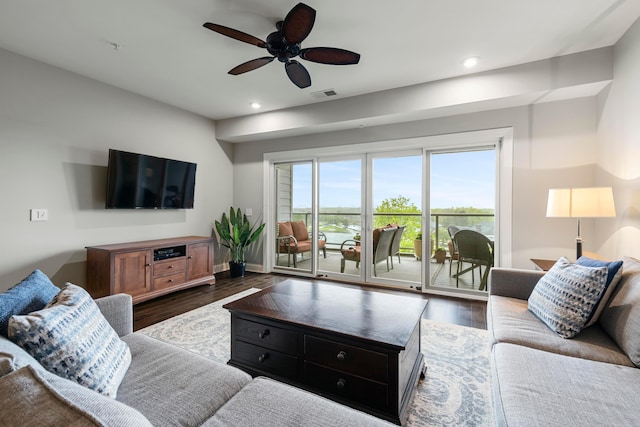 living area with recessed lighting, visible vents, ceiling fan, and dark wood-type flooring