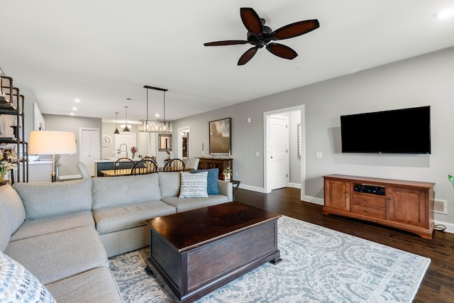 living room featuring baseboards, recessed lighting, ceiling fan, and dark wood-style floors
