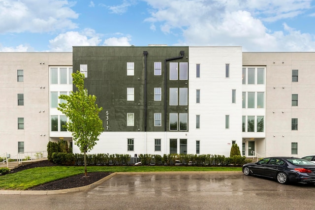view of building exterior featuring uncovered parking