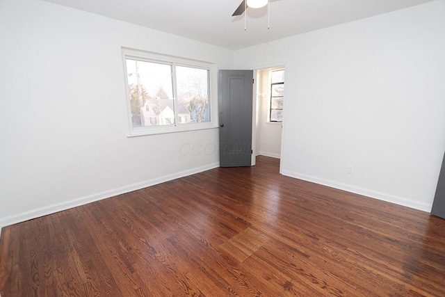 unfurnished room featuring baseboards, ceiling fan, and wood finished floors