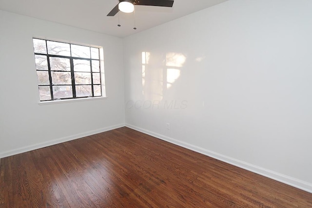 unfurnished room with baseboards, ceiling fan, and wood finished floors