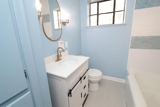 full bath with vanity, baseboards, bathing tub / shower combination, and toilet
