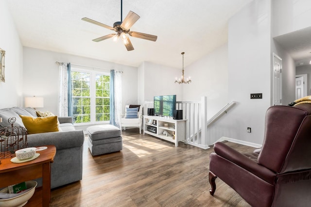 living area featuring ceiling fan with notable chandelier, wood finished floors, and lofted ceiling
