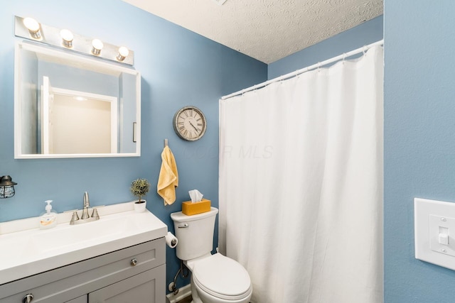 bathroom with vanity, a textured ceiling, a shower with shower curtain, and toilet