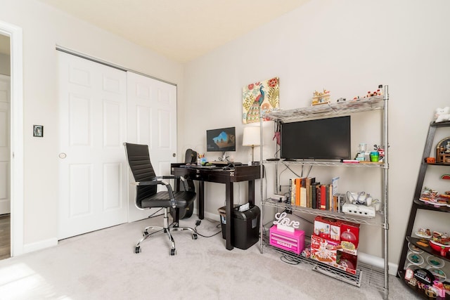 carpeted home office with baseboards