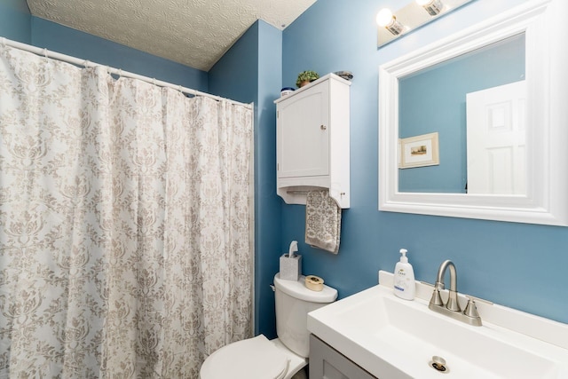bathroom featuring toilet, a textured ceiling, a shower with shower curtain, and vanity