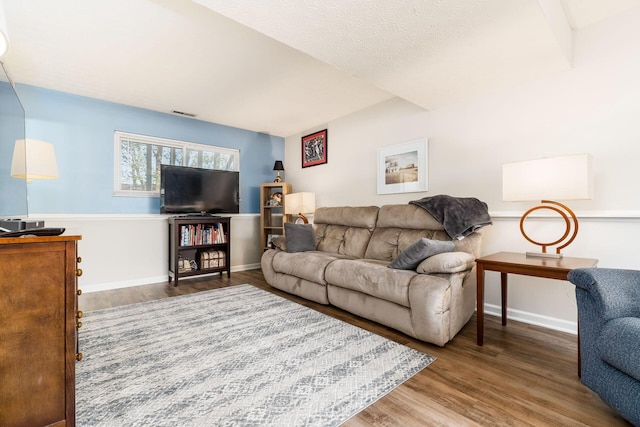 living room with baseboards and wood finished floors