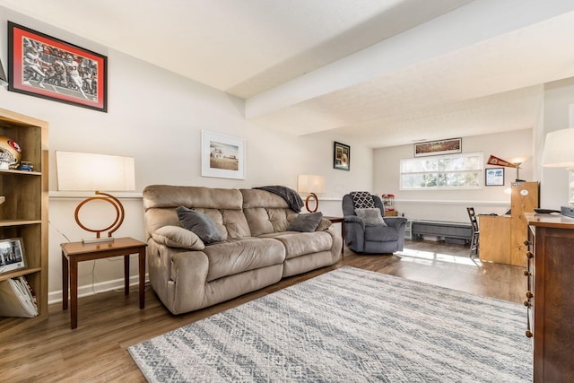 living area with baseboards, wood finished floors, and baseboard heating