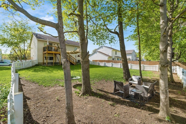 view of yard with stairs, a fenced backyard, a wooden deck, and a residential view