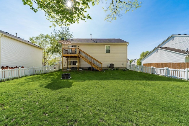 rear view of house featuring stairway, a deck, a fenced backyard, and an outdoor fire pit