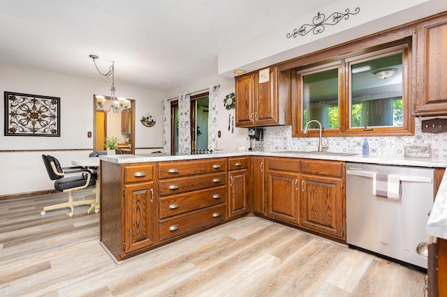 333 Salem Rd, Caledonia, OH 43314 - kitchen featuring dishwasher, a sink, brown cabinetry, and a peninsula