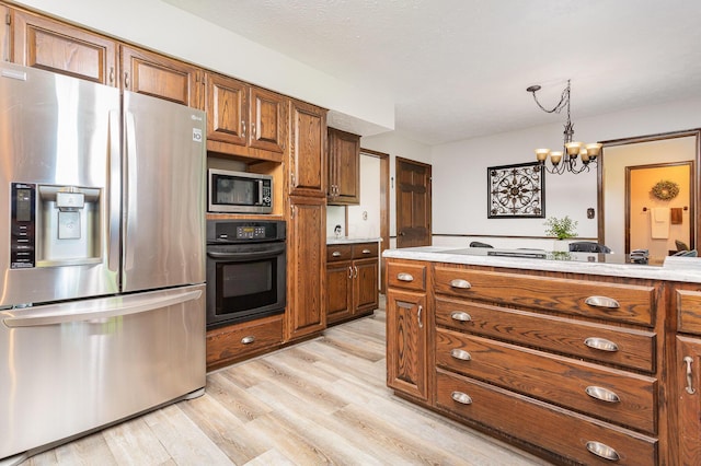 333 Salem Rd, Caledonia, OH 43314 - kitchen featuring appliances with stainless steel finishes, brown cabinetry, light countertops, and light wood-style floors