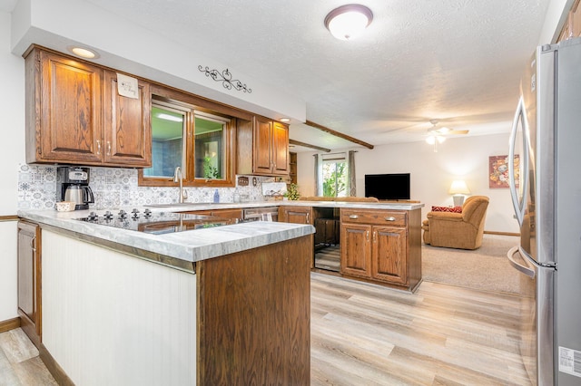 333 Salem Rd, Caledonia, OH 43314 - kitchen featuring a peninsula, freestanding refrigerator, open floor plan, a ceiling fan, and light wood-style flooring