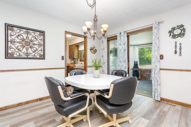 333 Salem Rd, Caledonia, OH 43314 - dining room with light wood-style floors, a chandelier, and baseboards